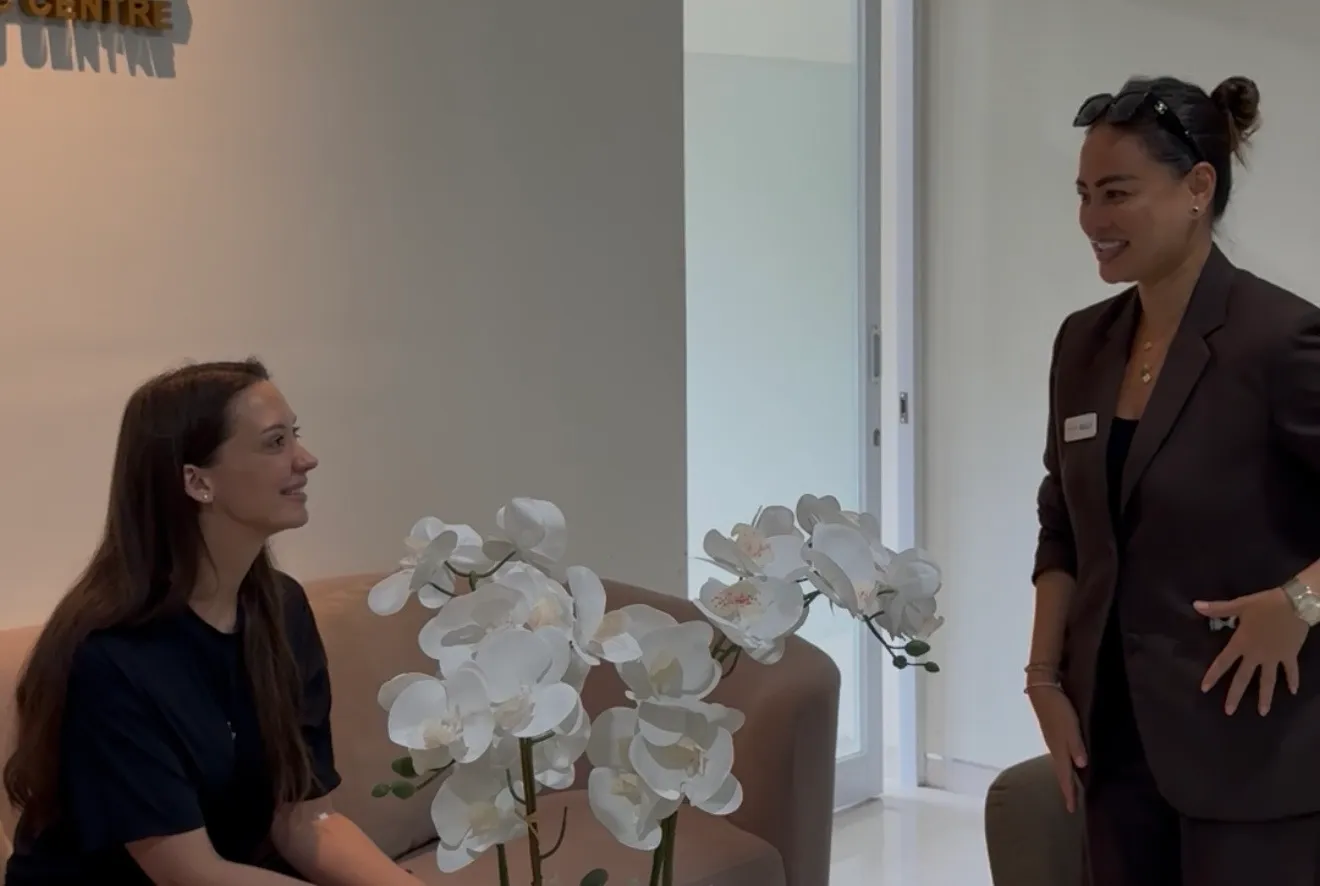 Patient resting and speaking with Client Manager Wully in RCC lounge